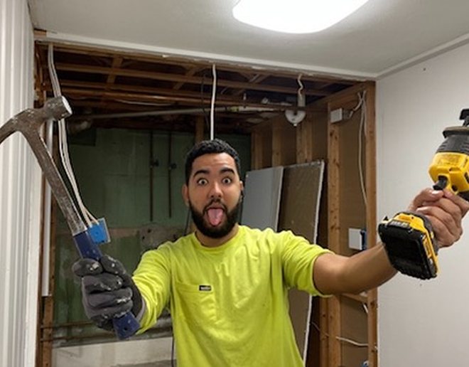 Mateus ready for demo with a hammer and a saw
