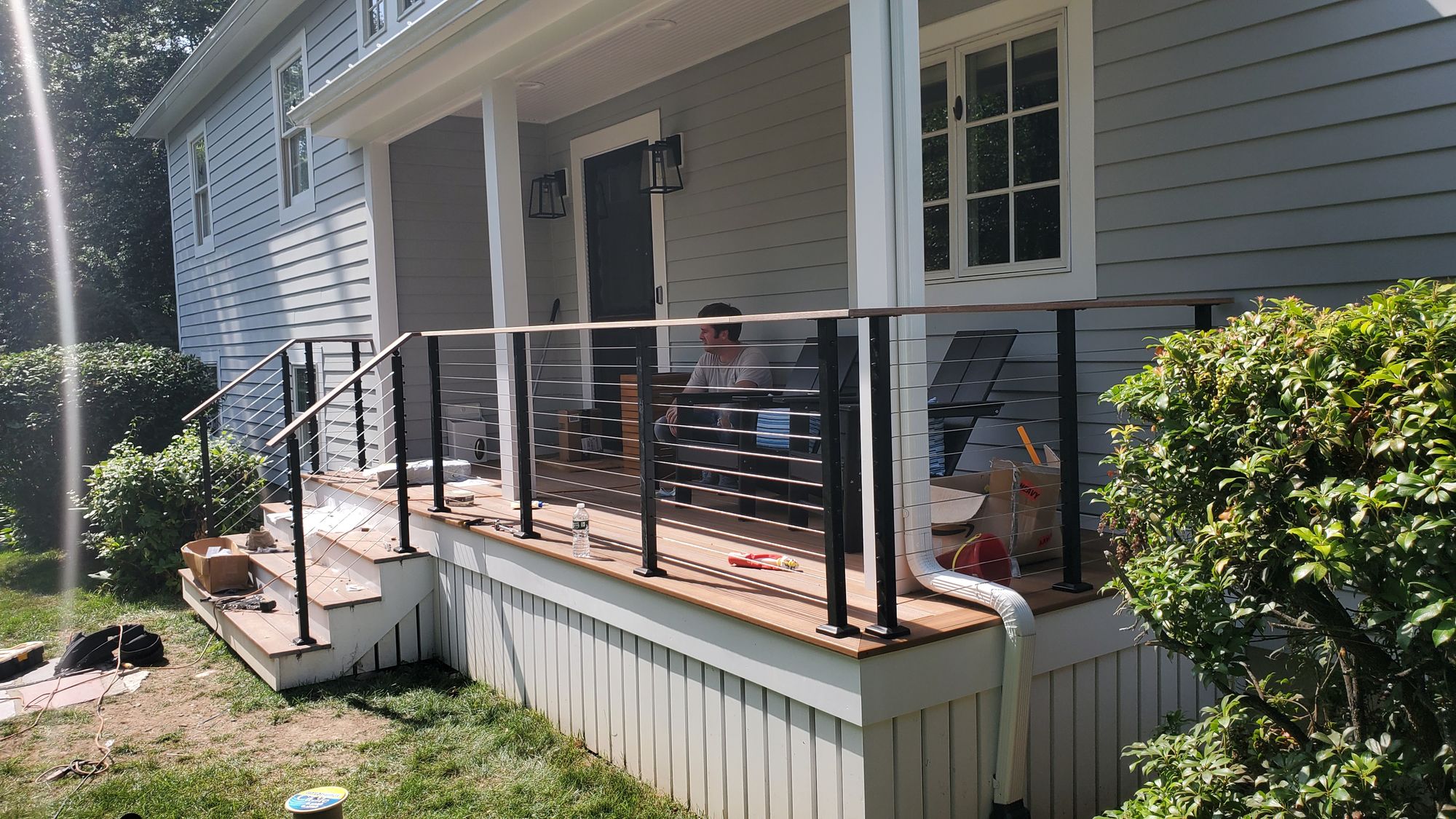 Front porch with composite stairs and black cable railing