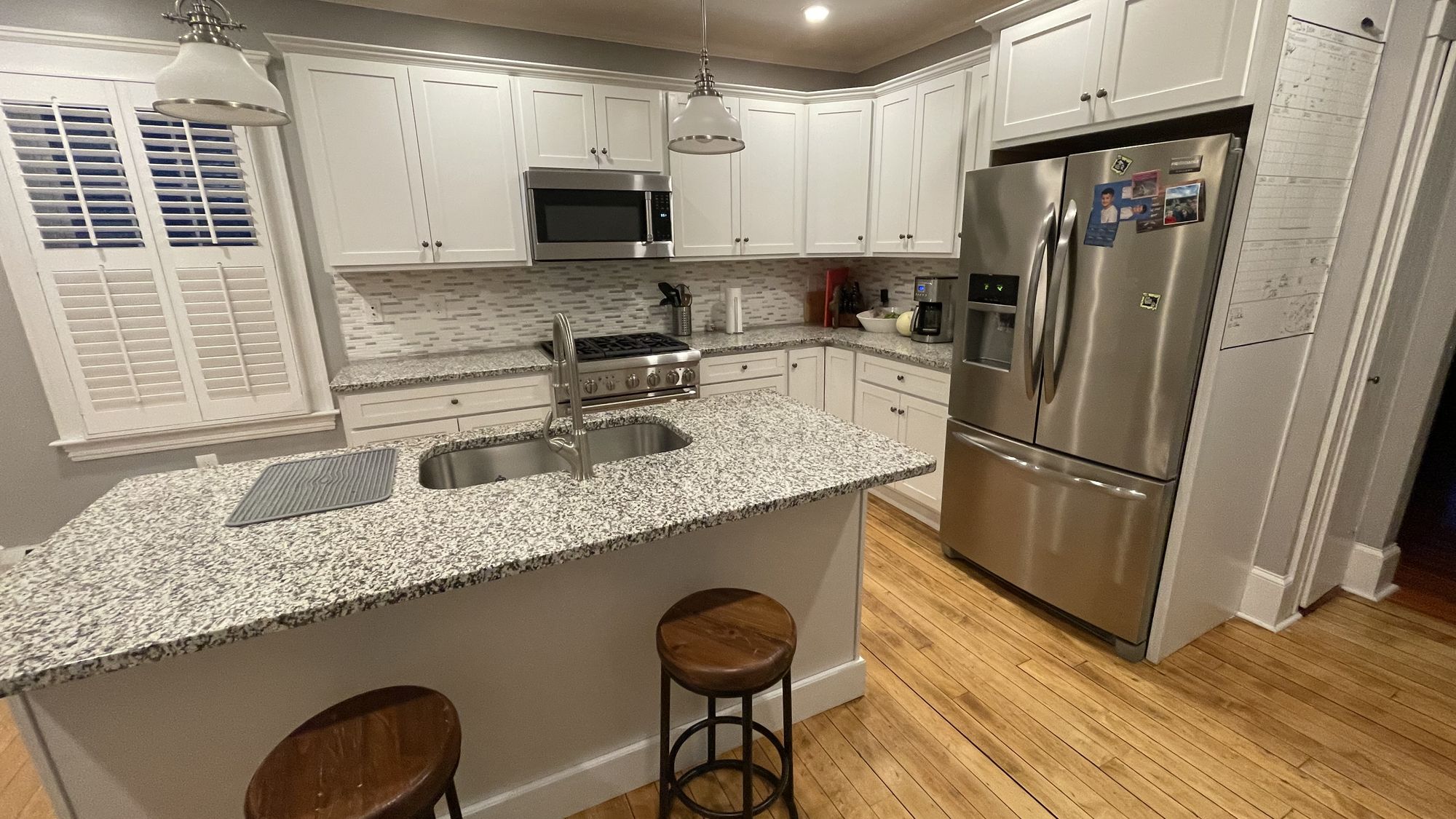 White kitchen with granite seating island