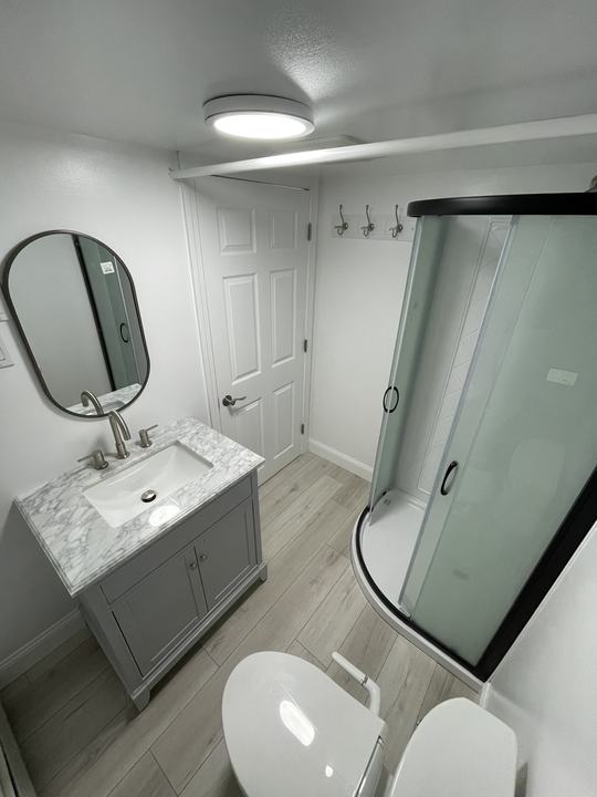 Finished bathroom with vanity and glass shower